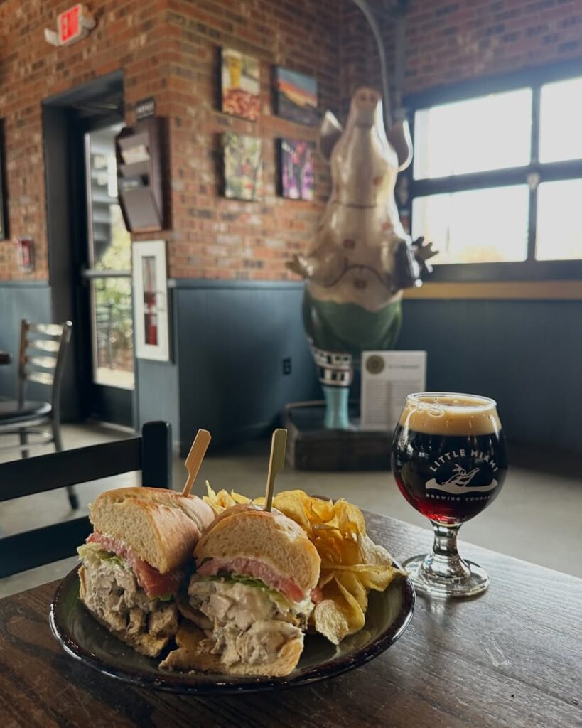 Special chicken ricotta sandwich served with kettle chips and a crisp beer at Little Miami Brewing Company.