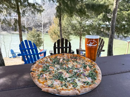 Shrimpalicious pizza and a cold craft beer on a table overlooking Adirondack chairs and river views at Little Miami Brewing Company.