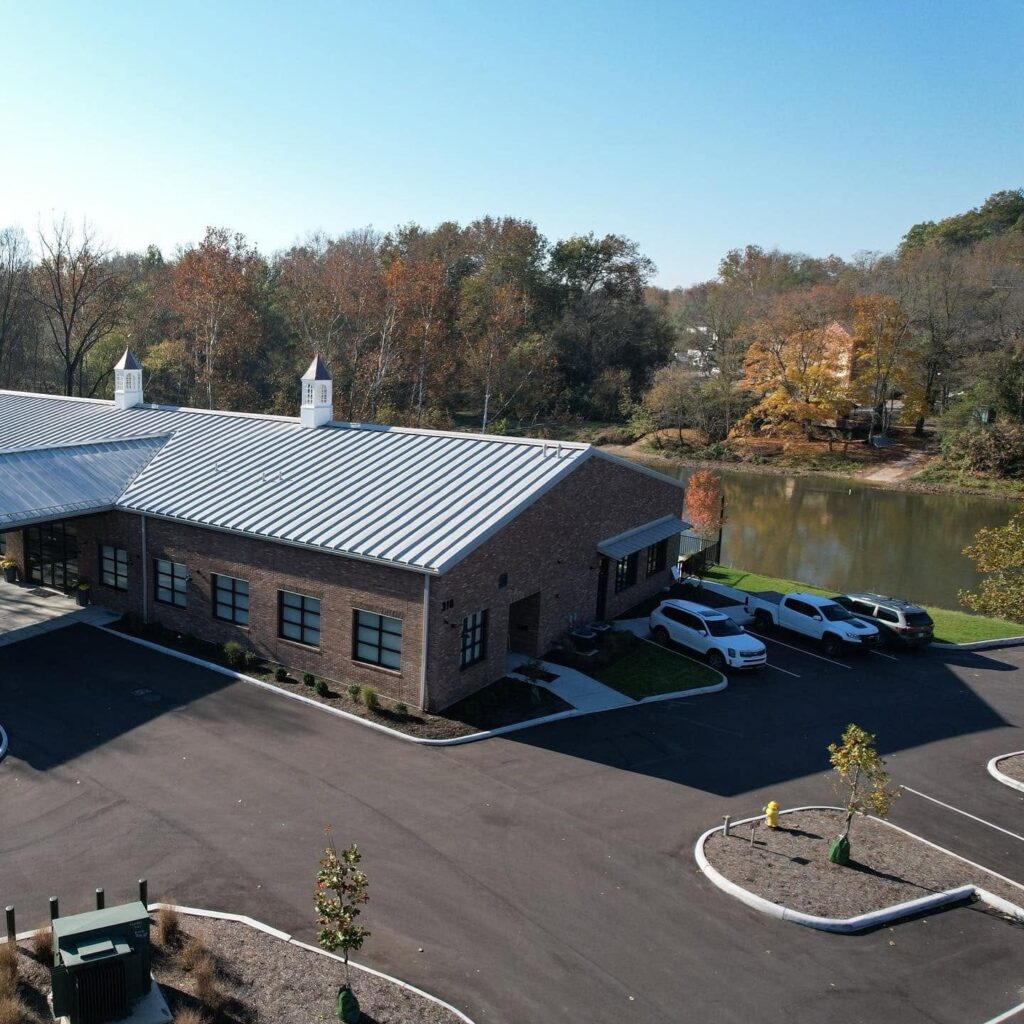 Aerial view of Little Miami Brewing Company Event Center along the Little Miami River, featuring outdoor gathering spaces and scenic riverfront surroundings.