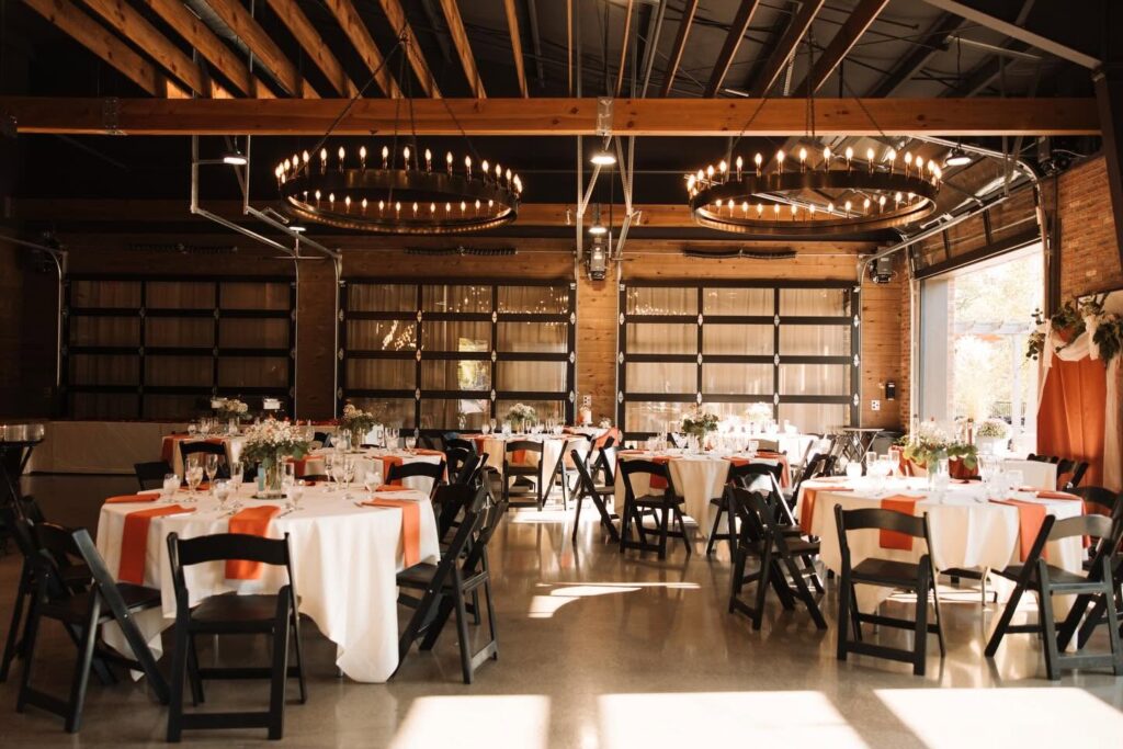 Little Miami Brewing Company Event Center with round tables, warm lighting, exposed beams, and rustic-industrial décor prepared for a private event.