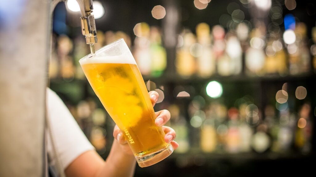 Beer being poured into a glass from a tap