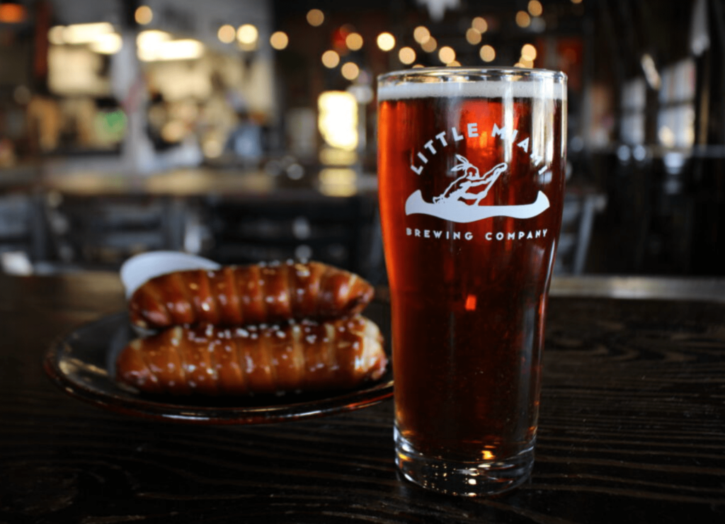 A pint of craft beer from Little Miami Brewing Company alongside soft pretzels, highlighting Cincinnati's brewing history