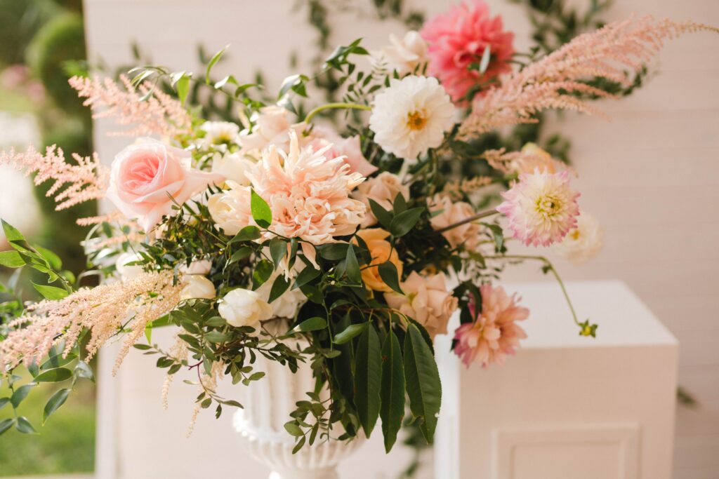 A romantic floral arrangements  with pastel blooms and lush greenery, perfect for weddings