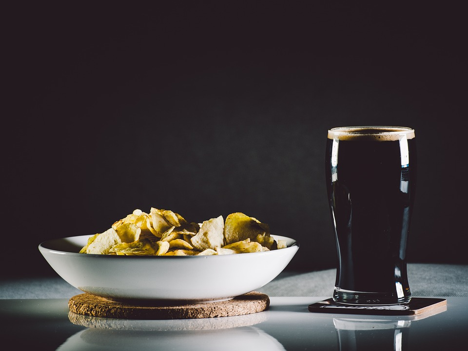 A glass of Little Miami craft beer with cheese platter appetizer