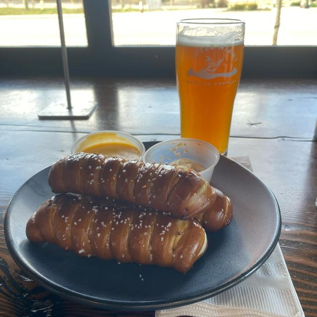 Shot of the best beer pairing featuring meat sandwiches, with dips, and Hazy IPA from Little Miami Brewing company.