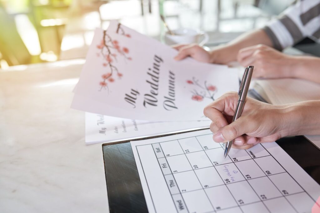 A couple excitedly planning their wedding, highlighting the joy and anticipation that comes with choosing wedding venues and making their dream day a reality.