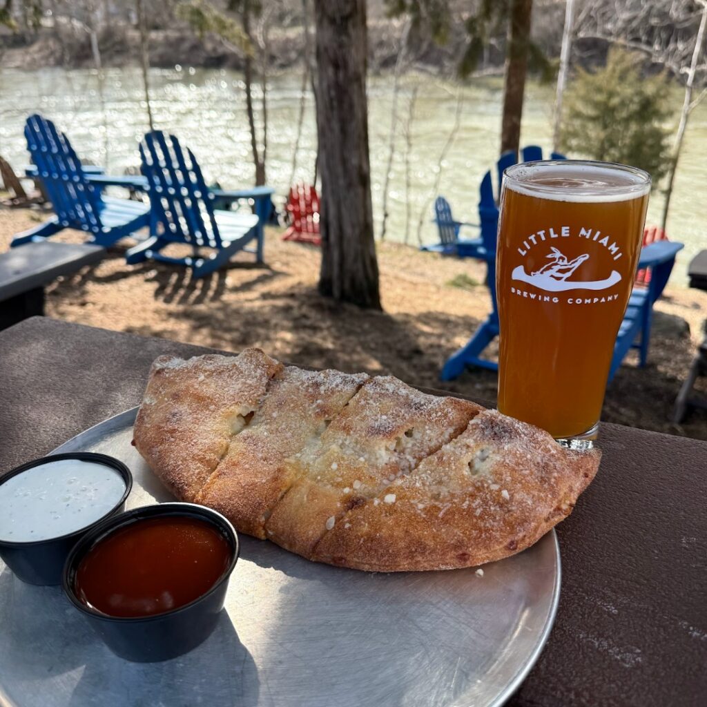 A Buffalo Shuffle Calzone served with buffalo sauce and a beer at LMBC.