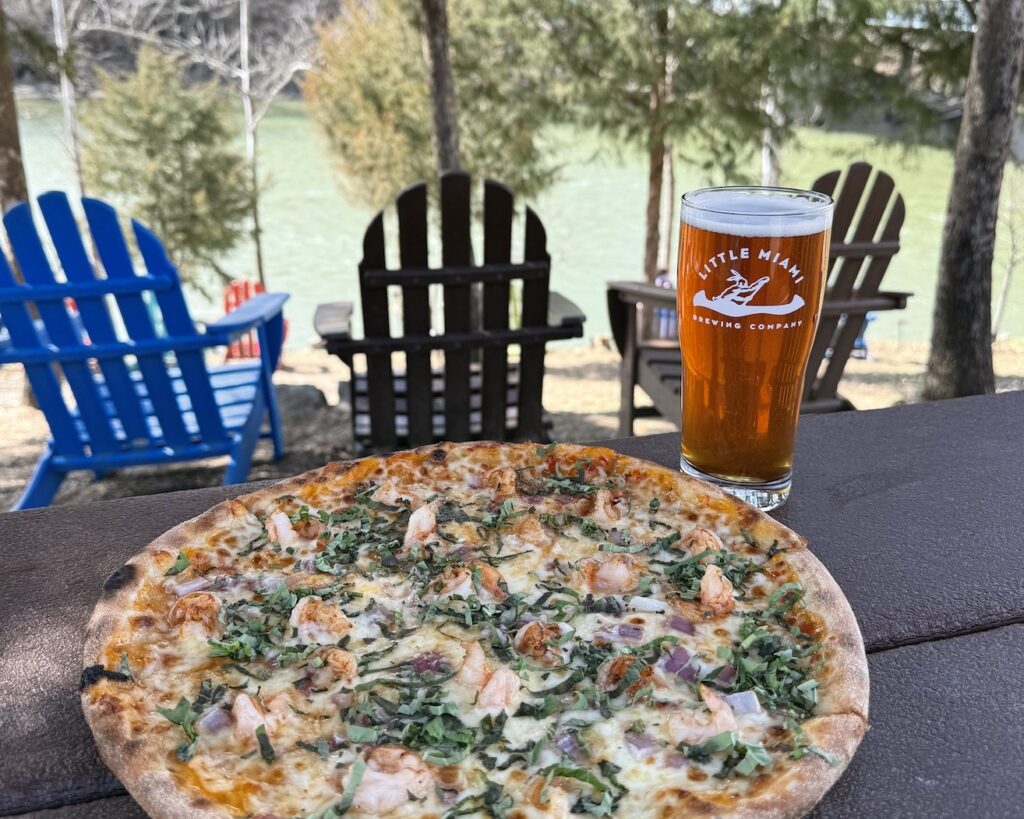 Delicious pizza and craft beer on a table outdoors at Little Miami Brewing Company.