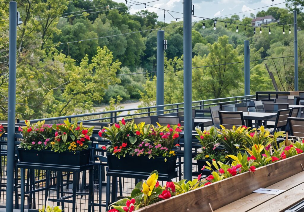 Riverside rooftop seating area with greenery and flowers at Little Miami Brewing Company.