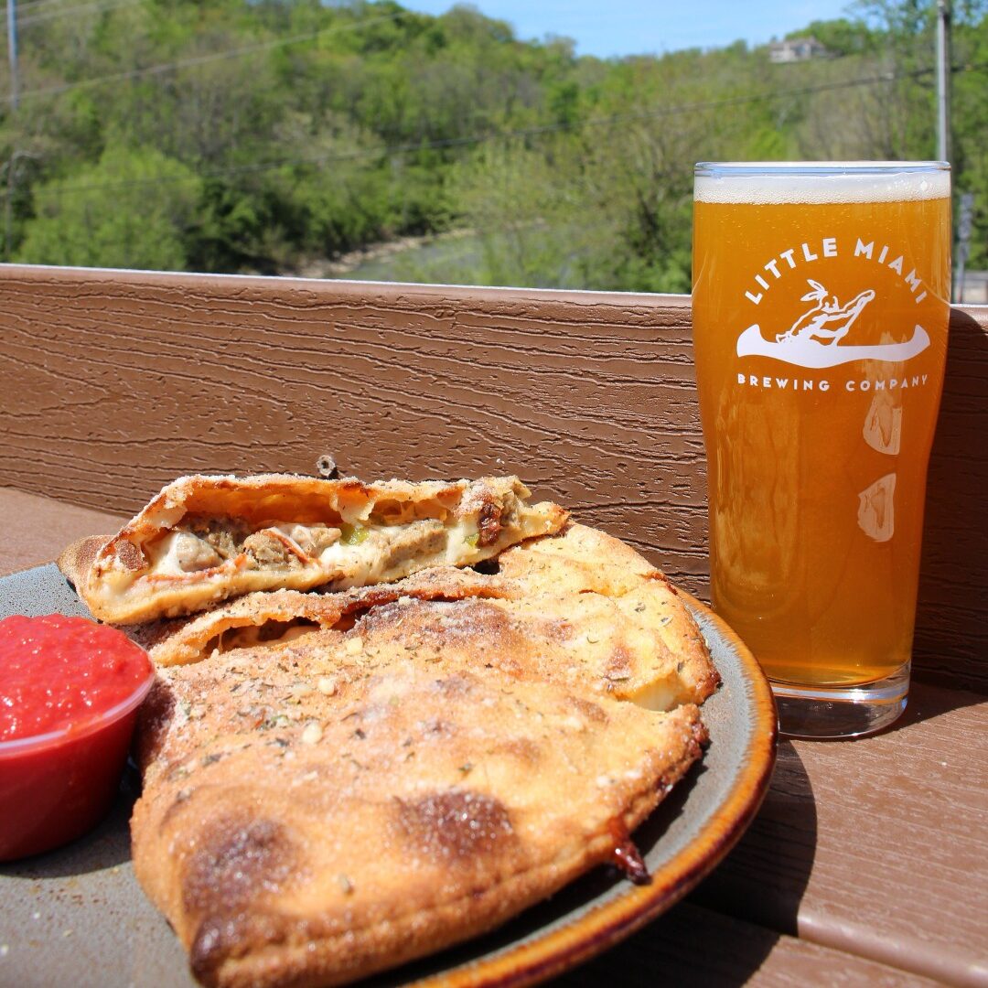 The Tony Pizza from Little Miami Brewing Company served with a frosty pint of craft beer.