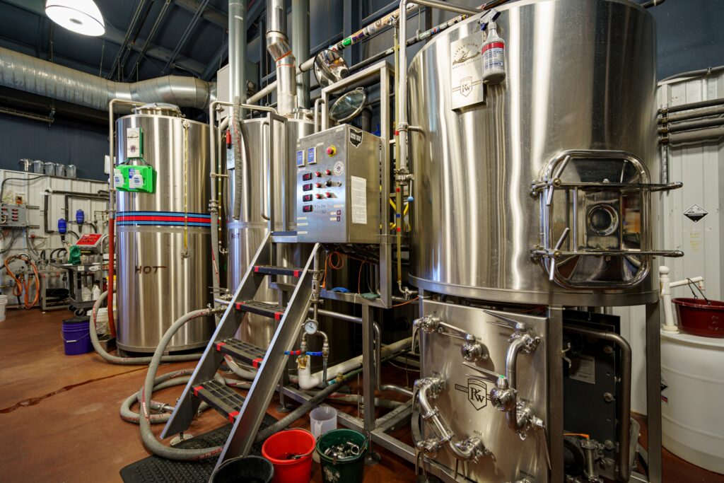 Large stainless steel brewing tanks and pipes at Little Miami Brewing Company.