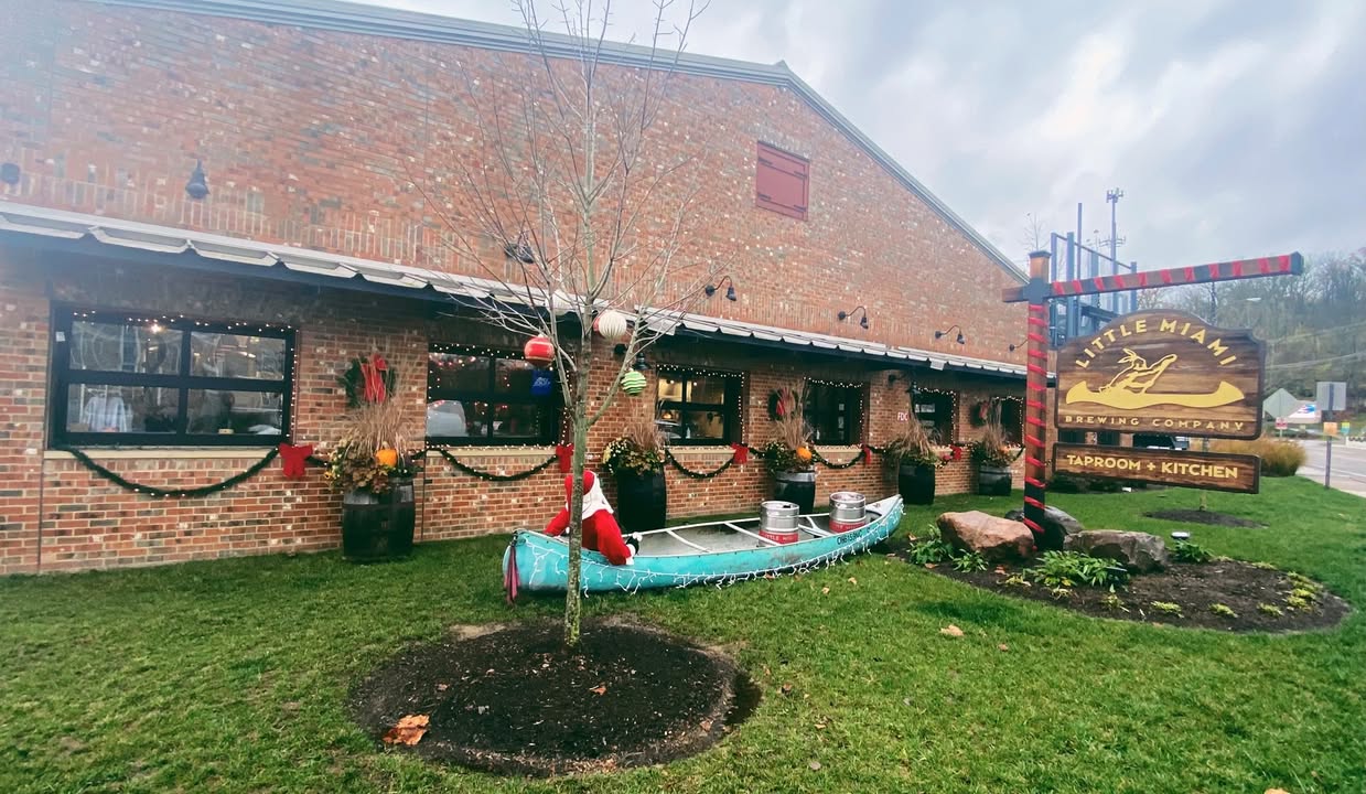 Exterior of Little Miami Brewing Company decorated for Thanksgiving, featuring warm lighting and seasonal outdoor décor.