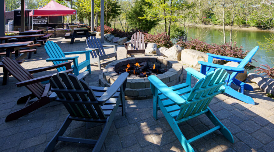 Riverside patio with a cozy firepit at Little Miami Brewing Company, offering a relaxing space to enjoy craft beer and beautiful river views.