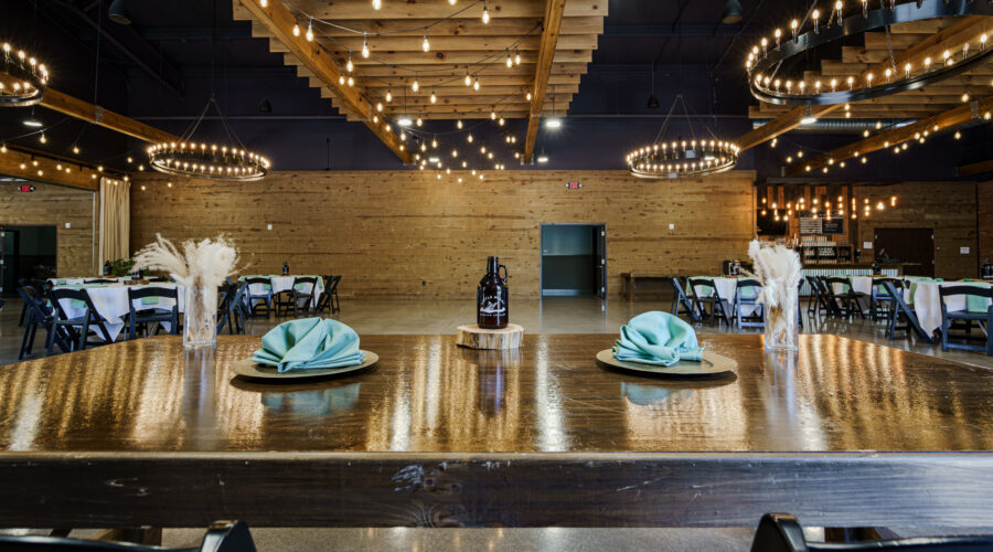 Little Miami Brewing Company’s industrial-elegant event center set with tables and chairs, ready for a private celebration.
