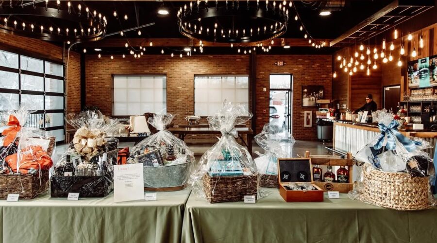 Holiday-themed fundraiser gift baskets arranged on a table at Little Miami Brewing Company Event Center.