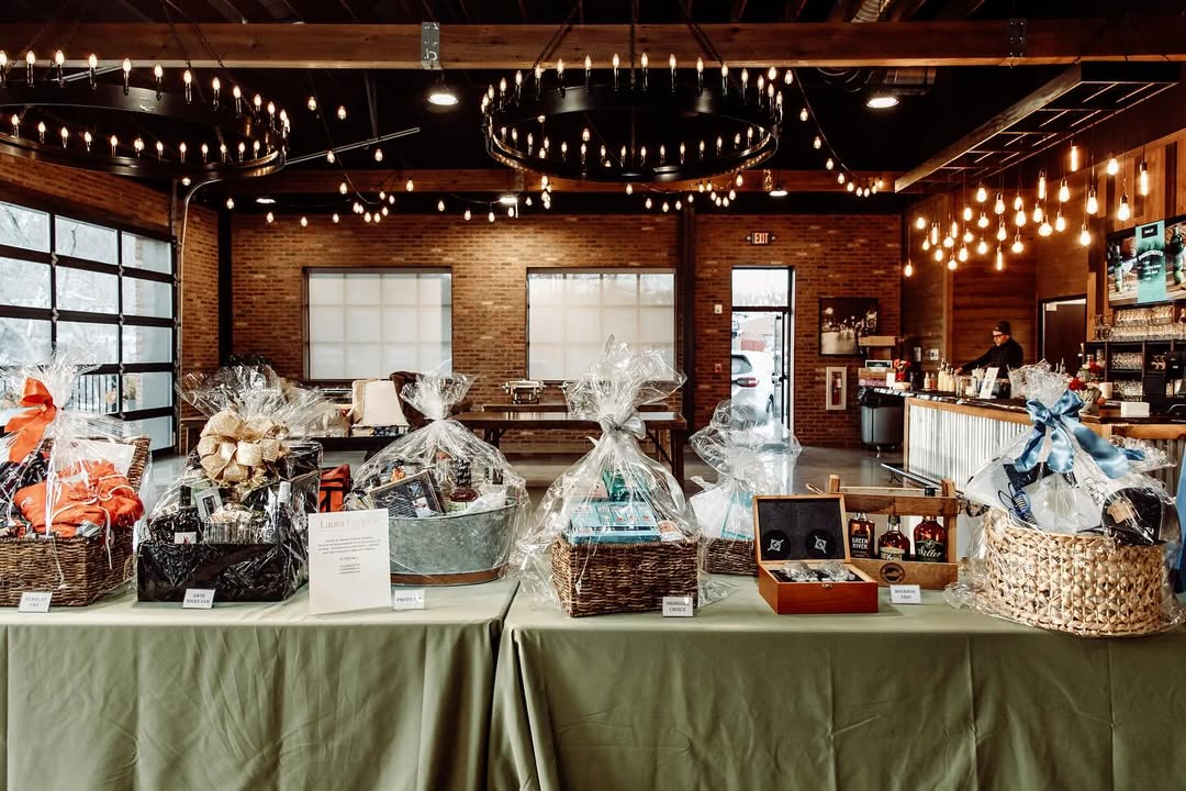 Holiday-themed fundraiser gift baskets arranged on a table at Little Miami Brewing Company Event Center.
