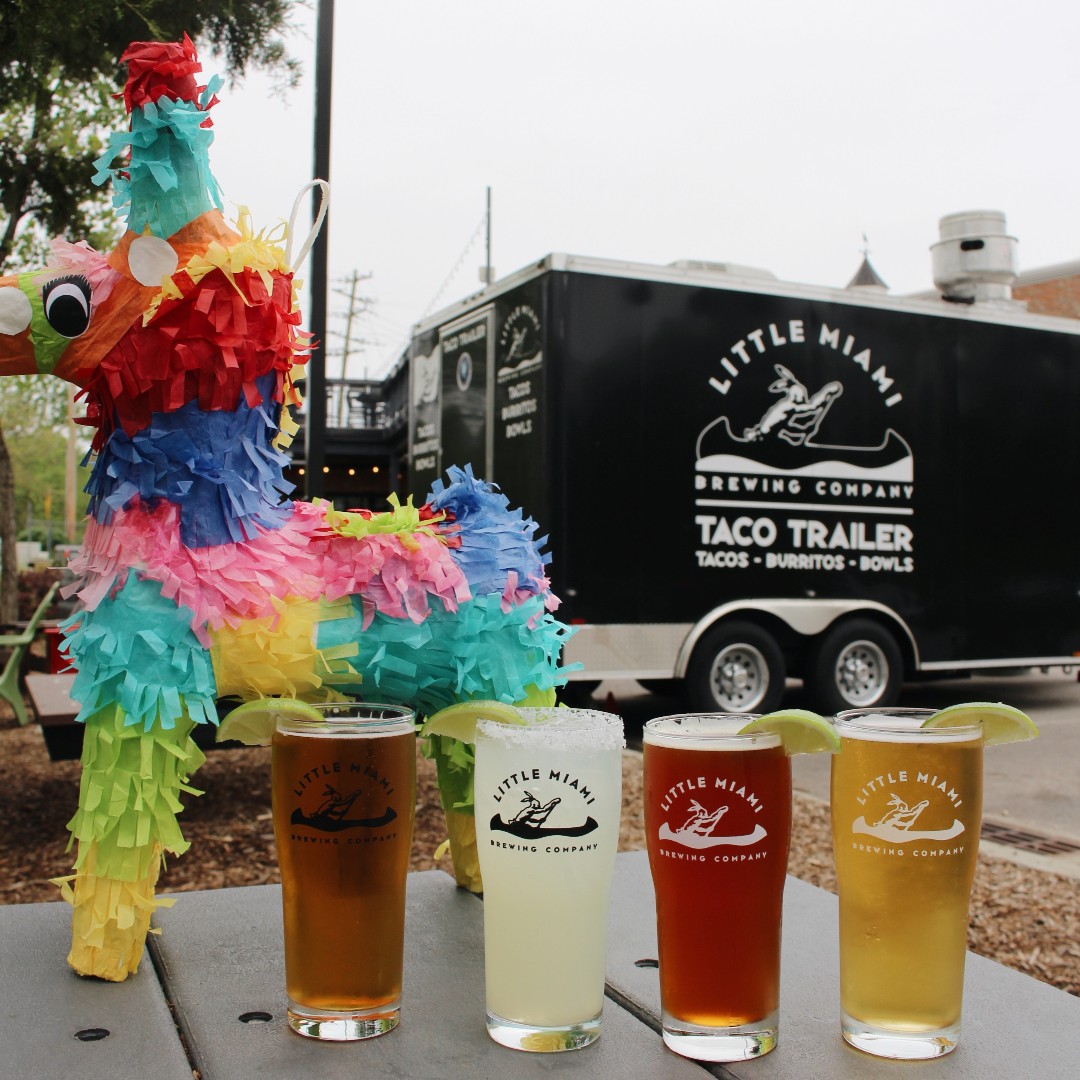 Little Miami Brewing Company’s diverse craft beers, including seasonal IPAs, with the Taco Trailer in the background.