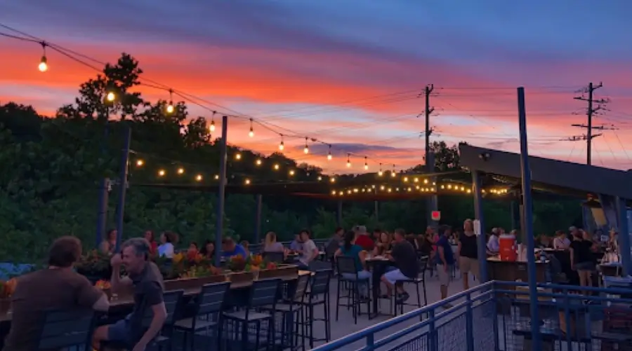 vibrant outdoor brewery setting at sunset,