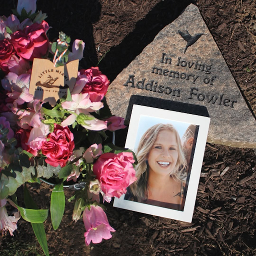 Memorial display honoring Addison Fowler with a framed photo and flowers at Little Miami Brewing Company.