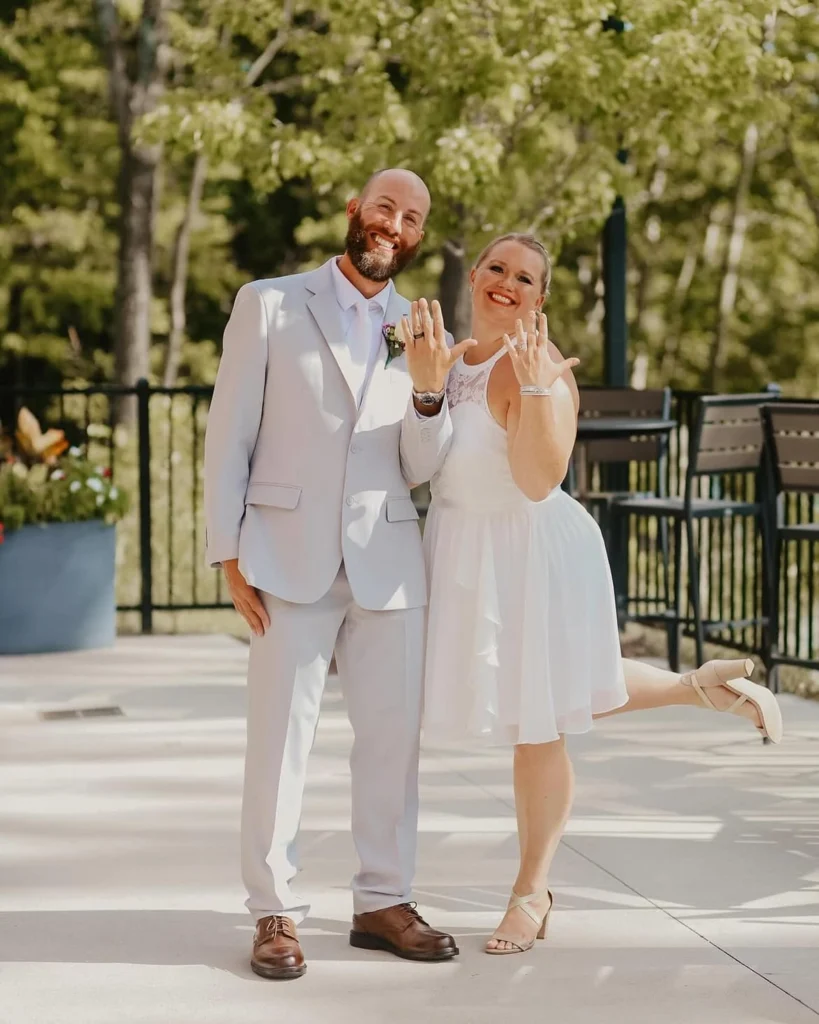 A newly engaged couple showing off their rings at the rooftop of Little Miami Brewing Company.