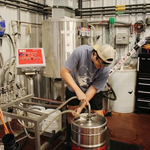 Brewer hand-filling a small-batch keg at Little Miami Brewing Company.