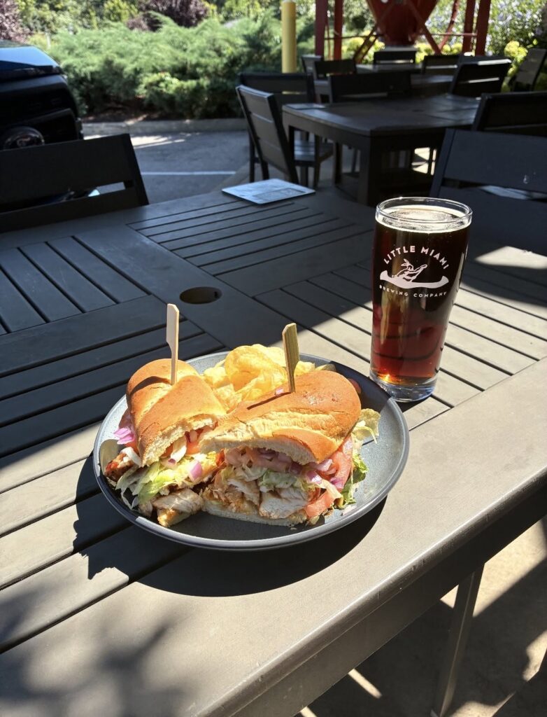 Wood-fired artisan pizza and drinks on an outdoor table at Little Miami Brewing Co. overlooking the Little Miami River.
